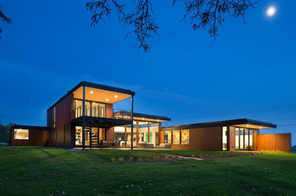 Example of a large minimalist brown two-story wood exterior home design in Milwaukee
