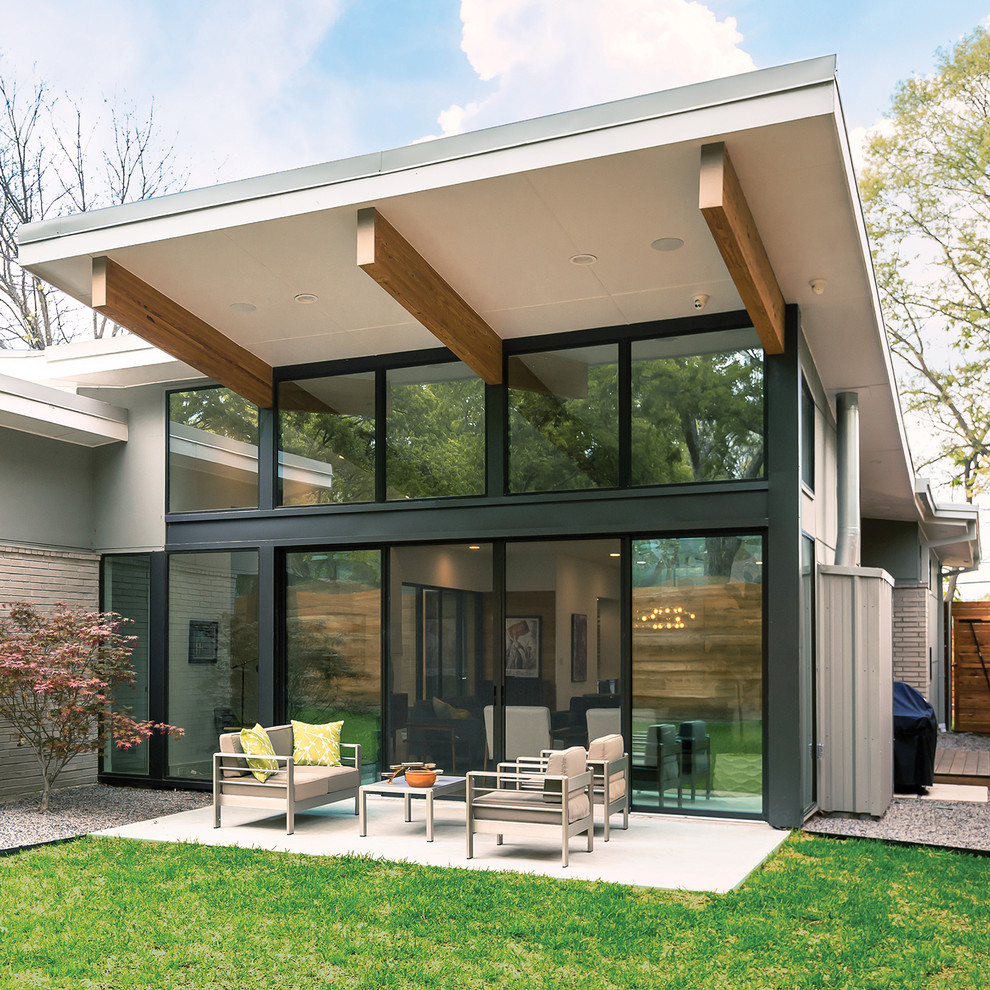 Mittelgroßes, Einstöckiges Modernes Einfamilienhaus mit Glasfassade, grauer Fassadenfarbe und Pultdach in Sonstige