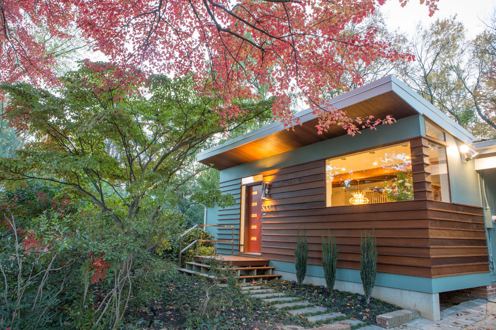 This is an example of a brown midcentury bungalow detached house in DC Metro with wood cladding and a lean-to roof.