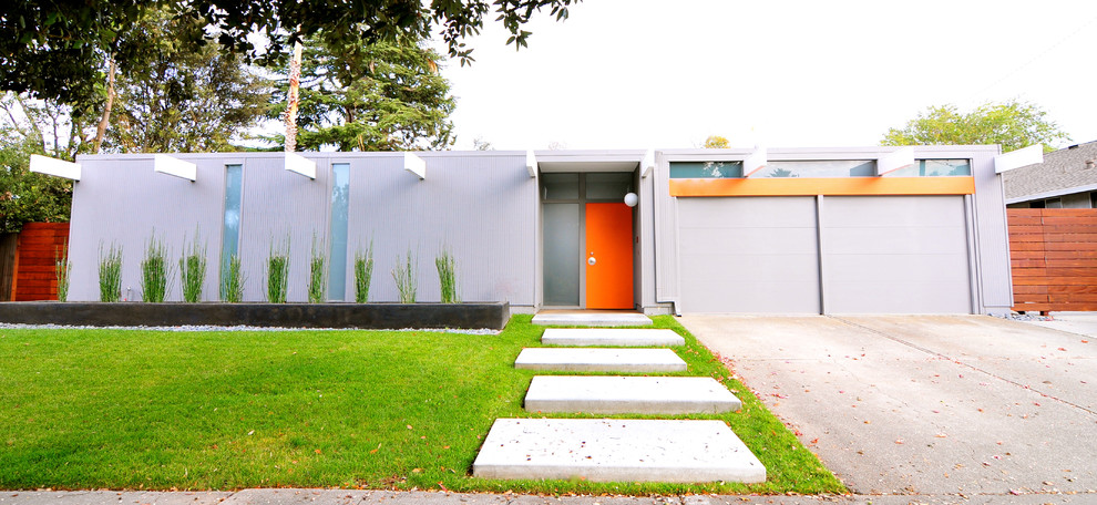 Photo of a gey midcentury bungalow house exterior in San Francisco with a flat roof.