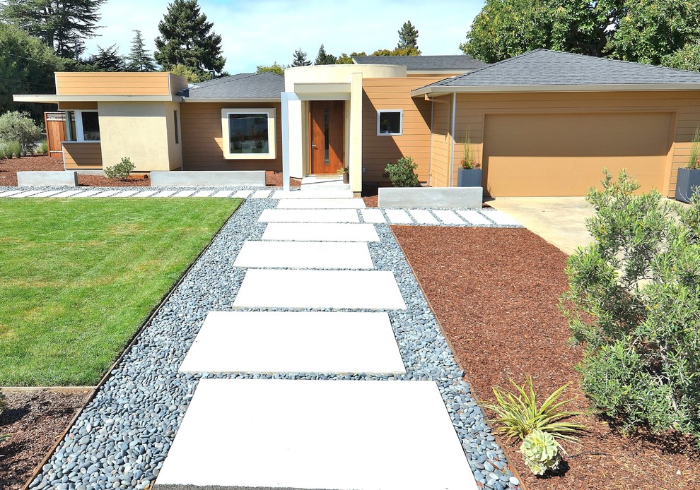 Example of a mid-sized mid-century modern multicolored one-story stucco house exterior design in San Francisco with a hip roof and a shingle roof