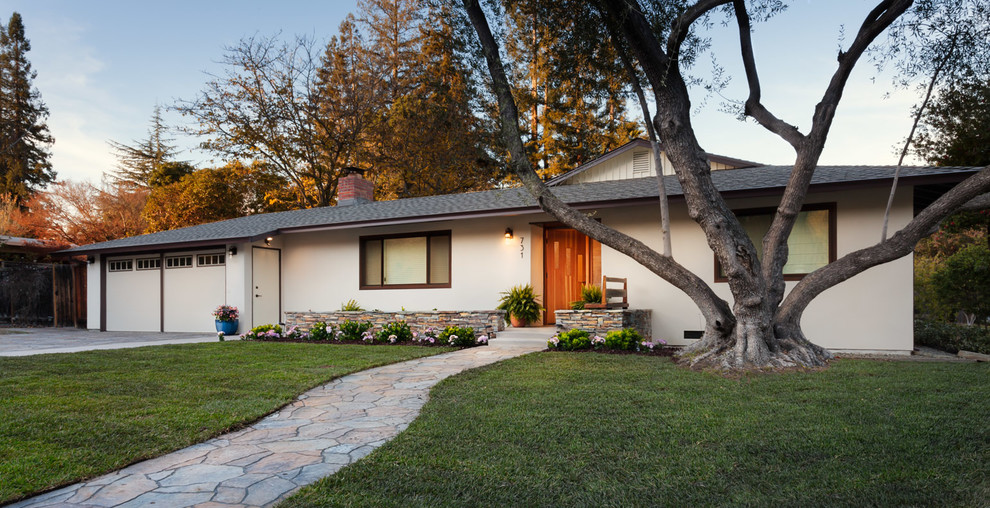 Photo of a medium sized and beige midcentury bungalow render house exterior in San Francisco with a flat roof.