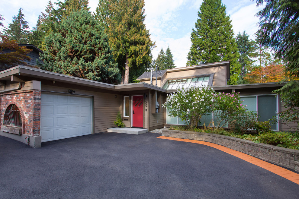Large mid-century modern brown two-story mixed siding house exterior idea in Vancouver with a shingle roof