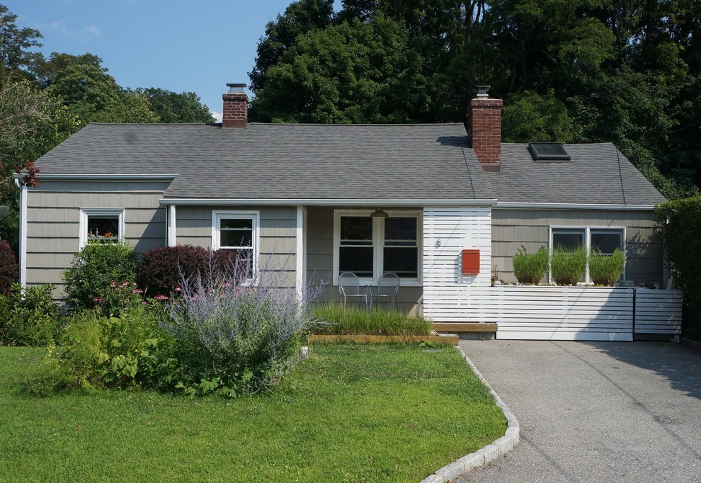 Mid-sized 1950s gray one-story wood house exterior photo in New York with a shingle roof
