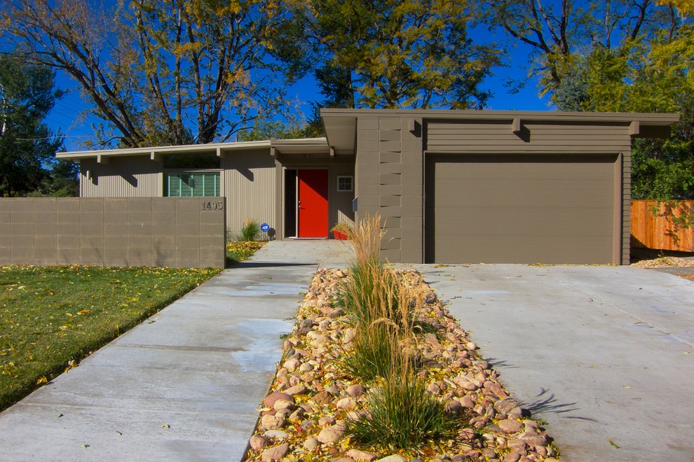 Inspiration for a small mid-century modern brown one-story mixed siding house exterior remodel in Denver with a shed roof
