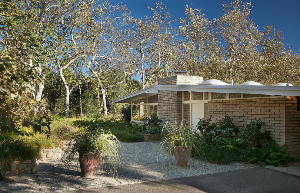 Example of a 1960s one-story brick gable roof design in Santa Barbara