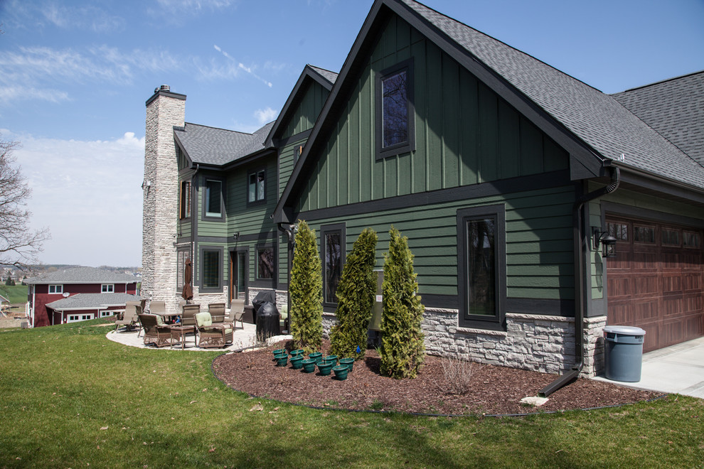 Transitional green two-story mixed siding house exterior idea in Other
