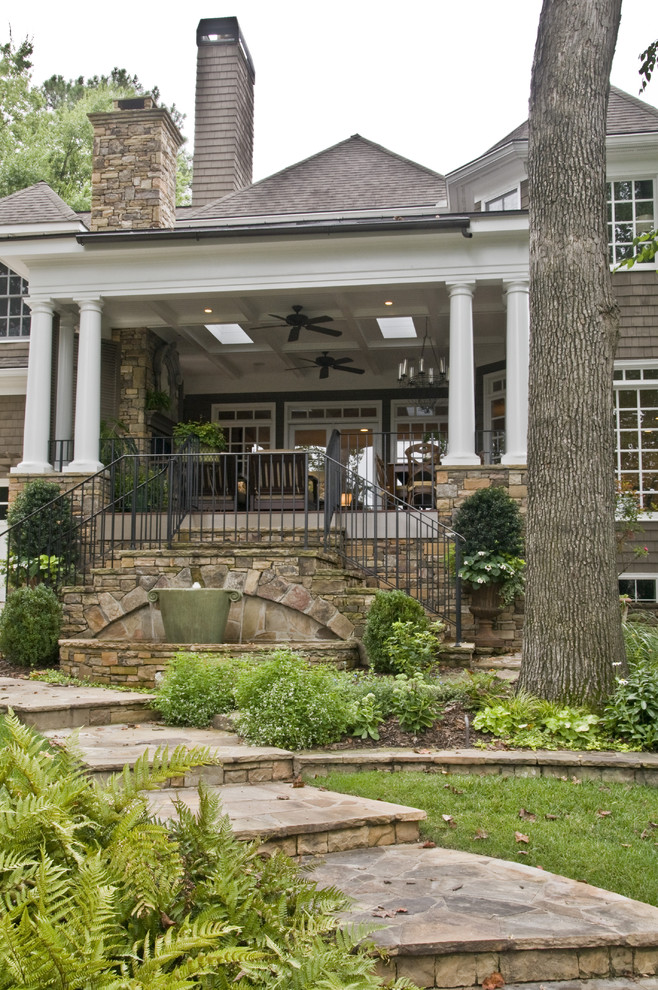 Inspiration for a traditional two floor house exterior in Atlanta with wood cladding.