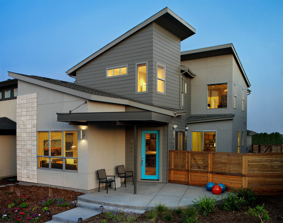 Contemporary gray two-story exterior home idea in Denver with a shed roof