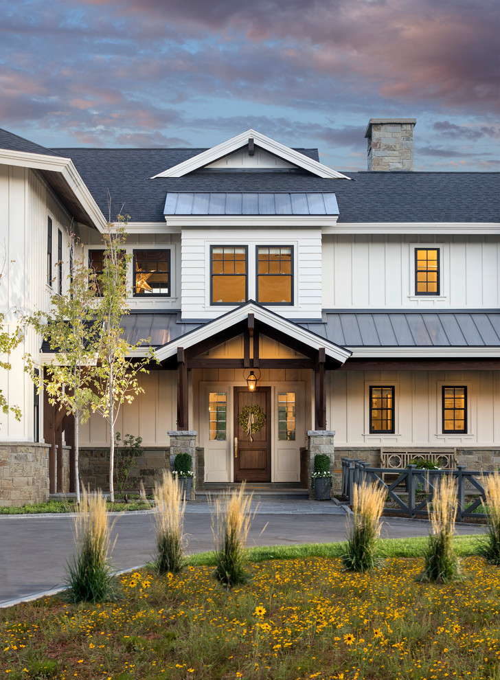 Inspiration for a country white two-story exterior home remodel in Salt Lake City with a mixed material roof