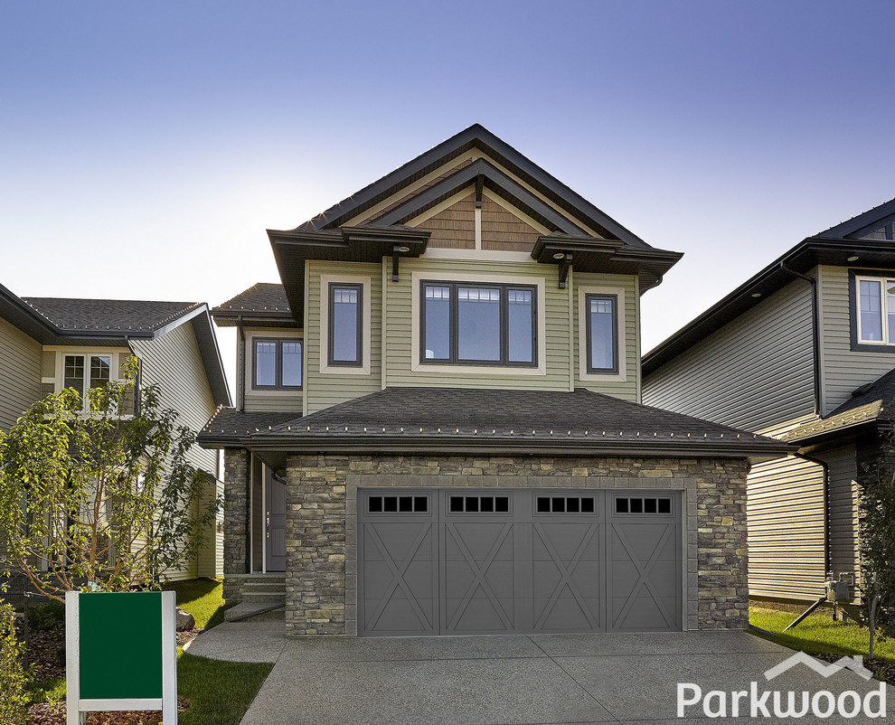 Cottage chic green two-story vinyl exterior home photo in Edmonton