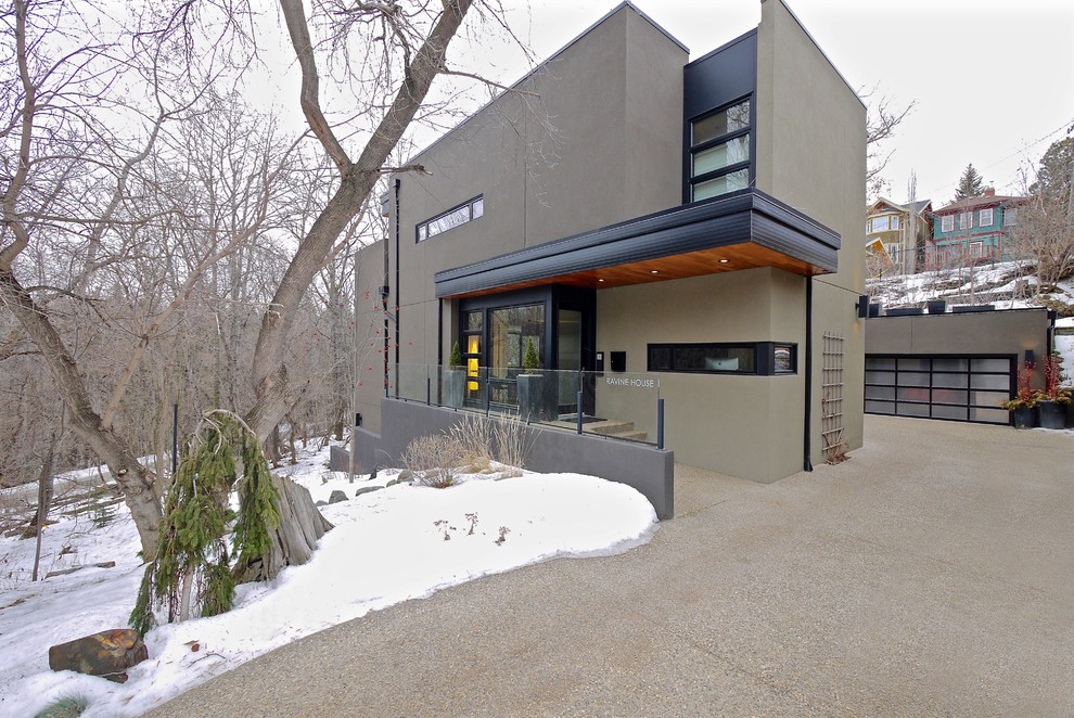 Mid-sized trendy gray two-story stucco flat roof photo in Edmonton