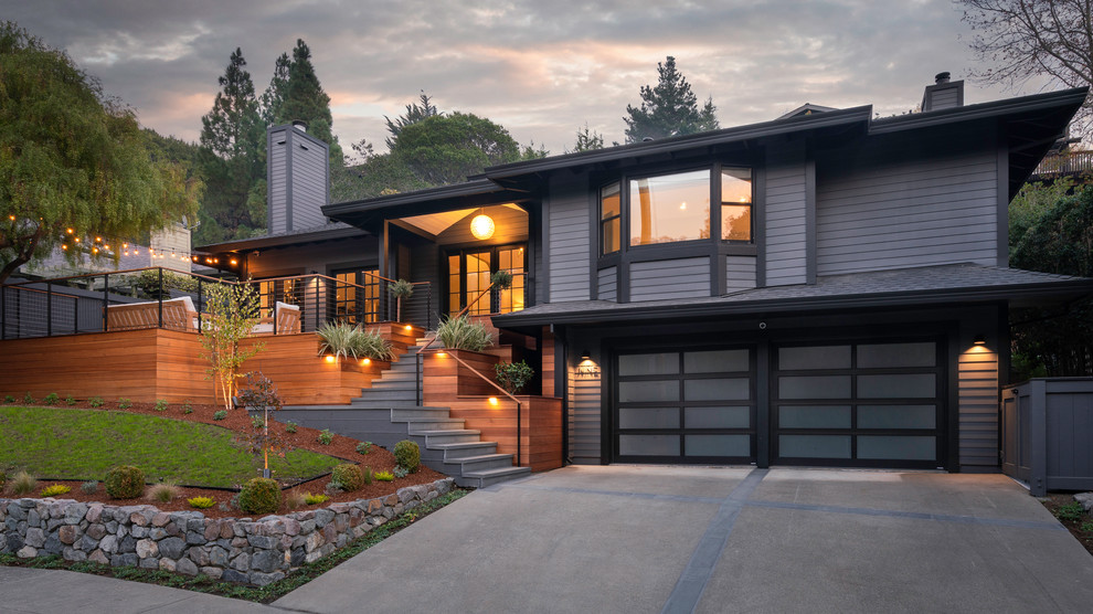Example of a large trendy gray two-story wood house exterior design in San Francisco with a hip roof