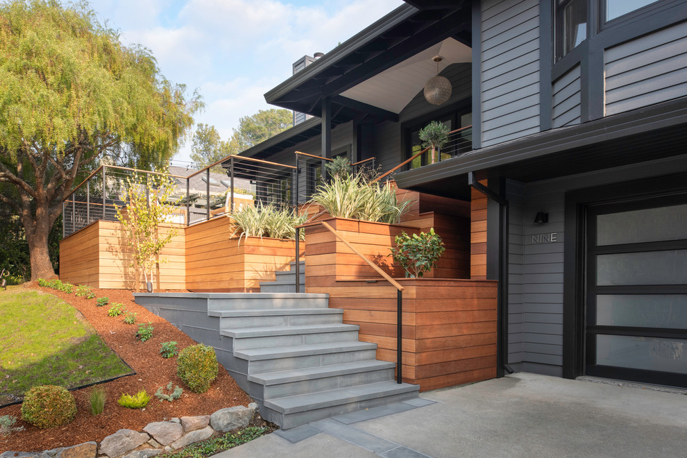 Inspiration for a large transitional gray two-story wood house exterior remodel in San Francisco with a hip roof and a shingle roof