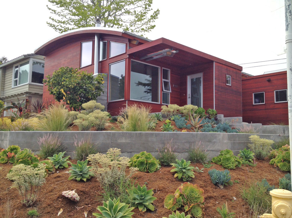 Inspiration pour une grande façade de maison rouge design en bois de plain-pied.