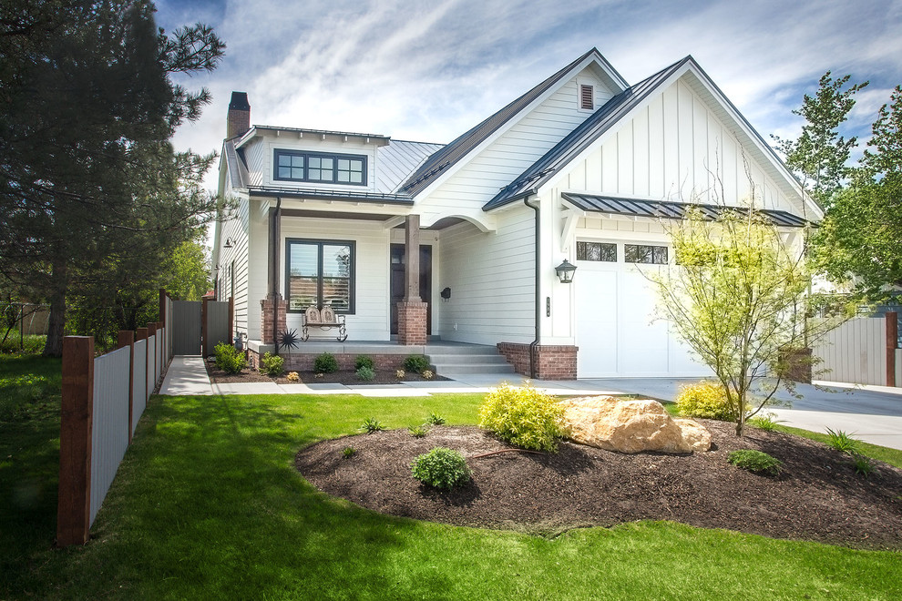 Mittelgroßes, Zweistöckiges Landhausstil Einfamilienhaus mit Vinylfassade, weißer Fassadenfarbe, Satteldach und Blechdach in Salt Lake City