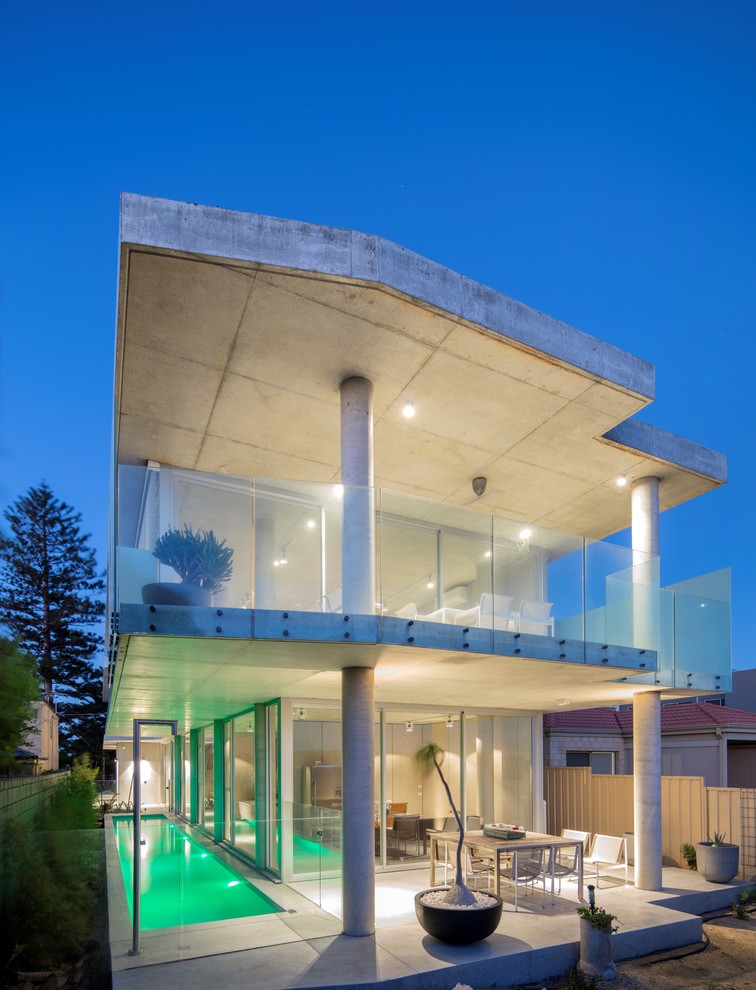 Photo of a gey urban two floor glass detached house in Perth with a flat roof and a mixed material roof.