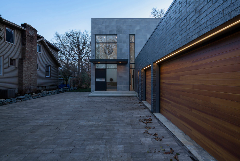 This is an example of a medium sized and gey modern two floor concrete detached house in Chicago with a flat roof.