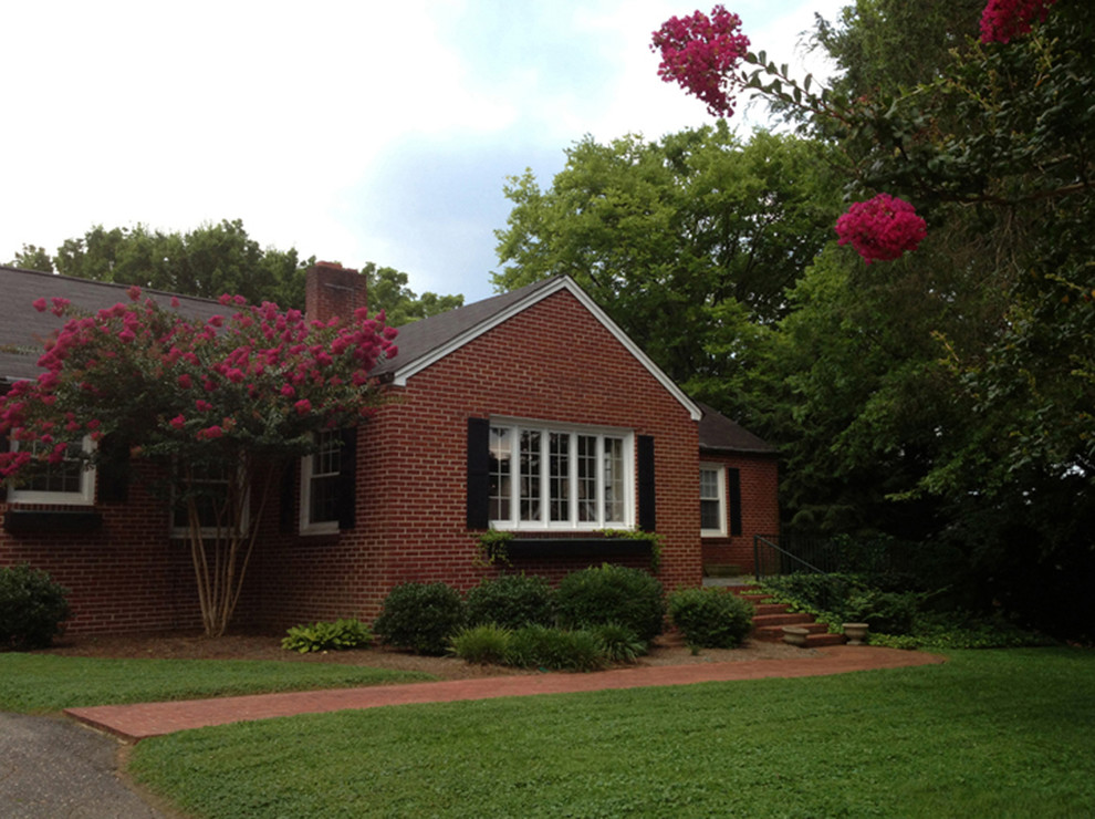 Mid-sized elegant red one-story brick gable roof photo in Charlotte