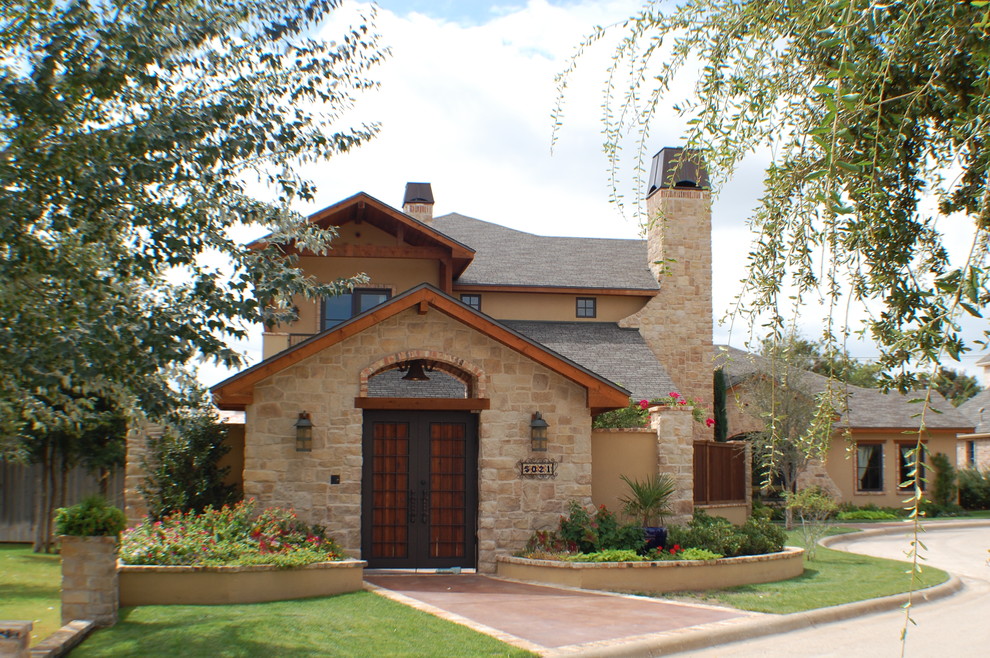 Mediterranean beige two-story stucco exterior home idea in Austin with a hip roof