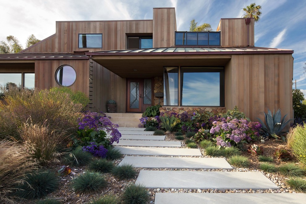Inspiration for a brown contemporary two floor detached house in Santa Barbara with wood cladding and a flat roof.