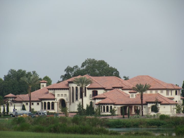 Example of a huge tuscan white two-story stucco exterior home design in Tampa with a hip roof