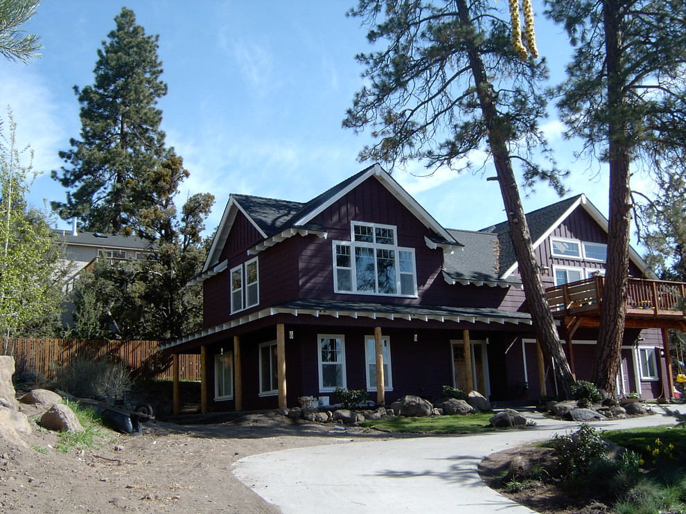 Example of a small arts and crafts multicolored two-story wood gable roof design in Other
