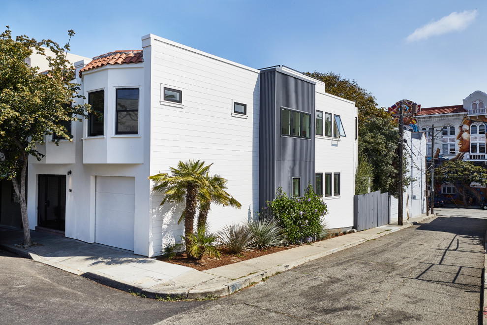 Photo of a large and white contemporary detached house in San Francisco with three floors and a flat roof.