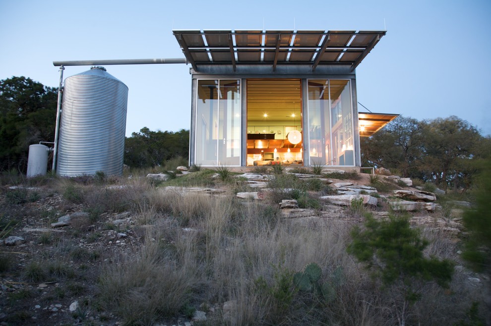 Kleines, Einstöckiges Modernes Haus mit Metallfassade und grauer Fassadenfarbe in Austin