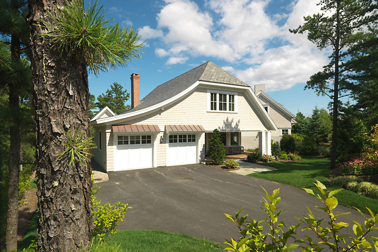 Inspiration for a large transitional gray two-story wood exterior home remodel in Boston with a clipped gable roof