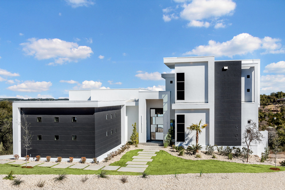 Imagen de fachada de casa multicolor contemporánea de dos plantas con revestimientos combinados y tejado plano