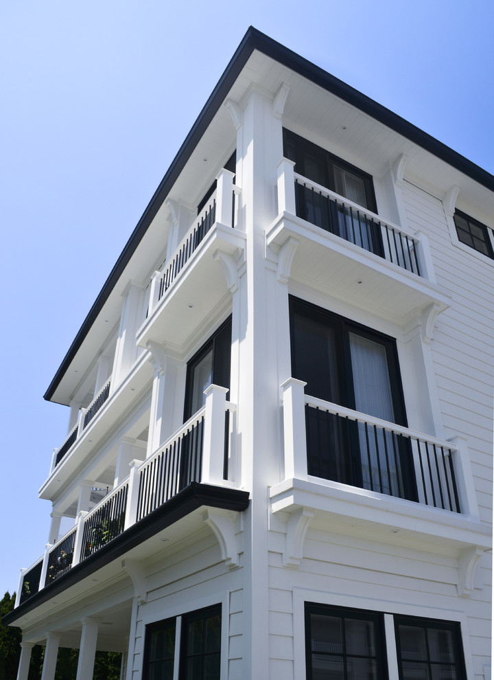 Large beach style white three-story vinyl house exterior photo in Other