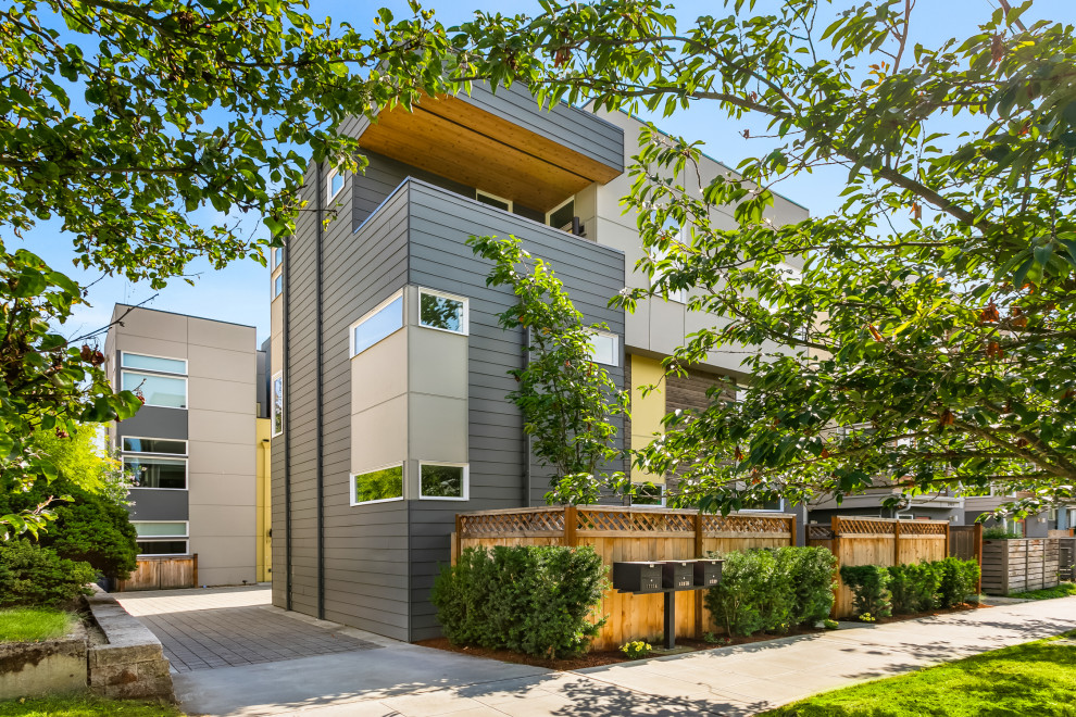 Diseño de fachada de casa pareada gris minimalista de tres plantas