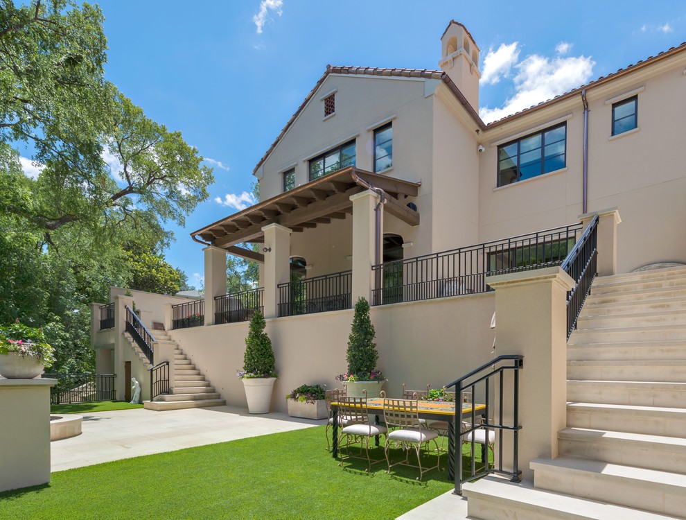 Photo of a beige mediterranean two floor house exterior in Dallas.