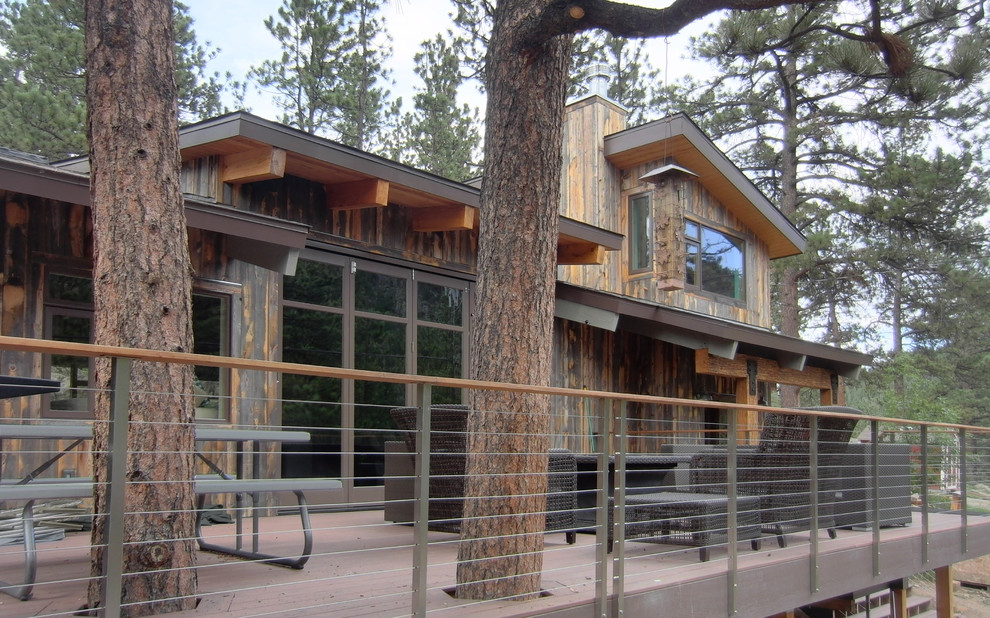 This is an example of a brown rustic two floor house exterior in Seattle with wood cladding.