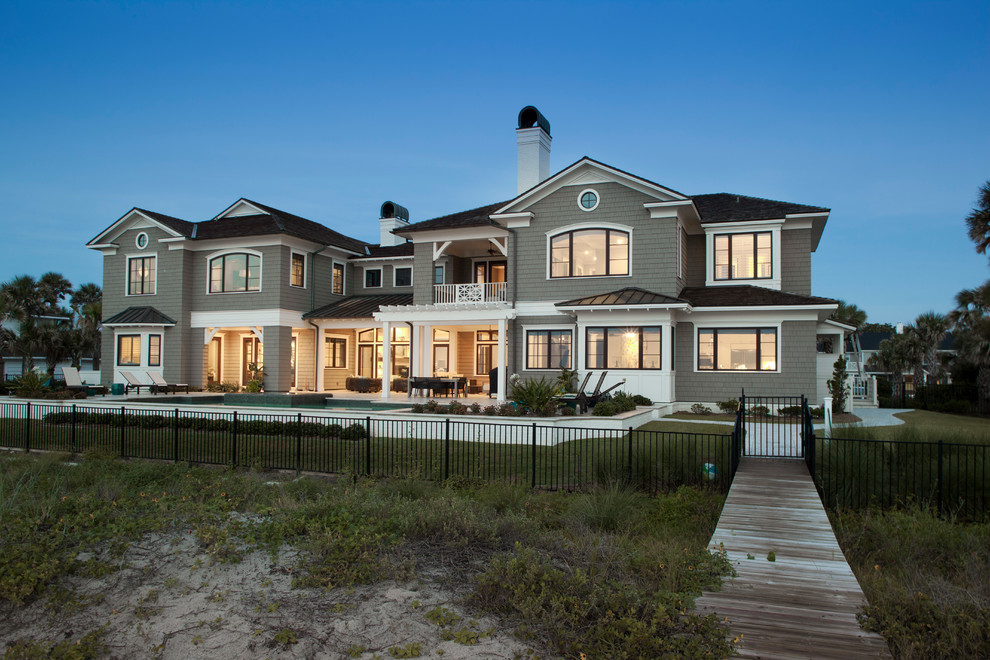 Inspiration for a large coastal beige two-story wood gable roof remodel in Jacksonville
