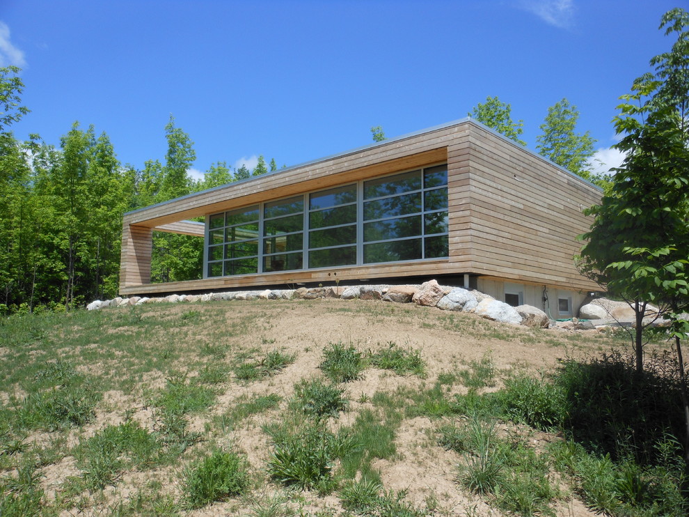 Exemple d'une façade de maison moderne en bois.