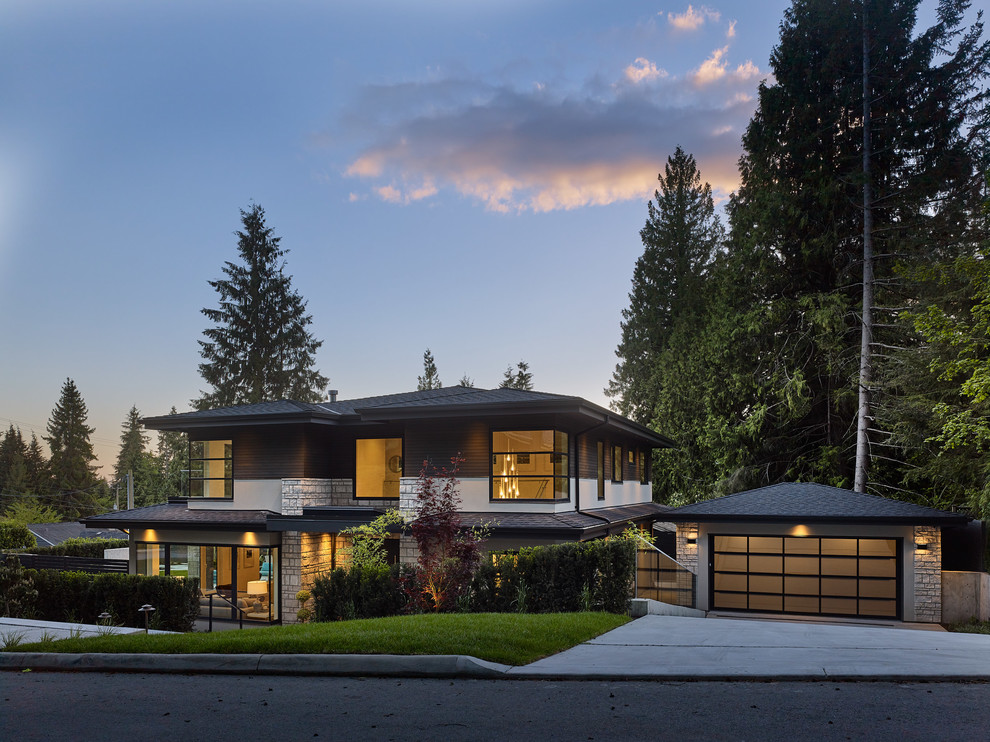 Inspiration for a large modern beige two-story mixed siding exterior home remodel in Vancouver with a shingle roof
