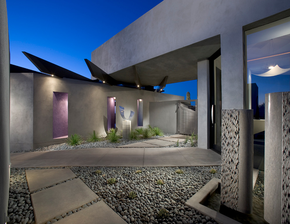 Пример оригинального дизайна: серый, одноэтажный частный загородный дом среднего размера в стиле модернизм с плоской крышей и облицовкой из бетона
