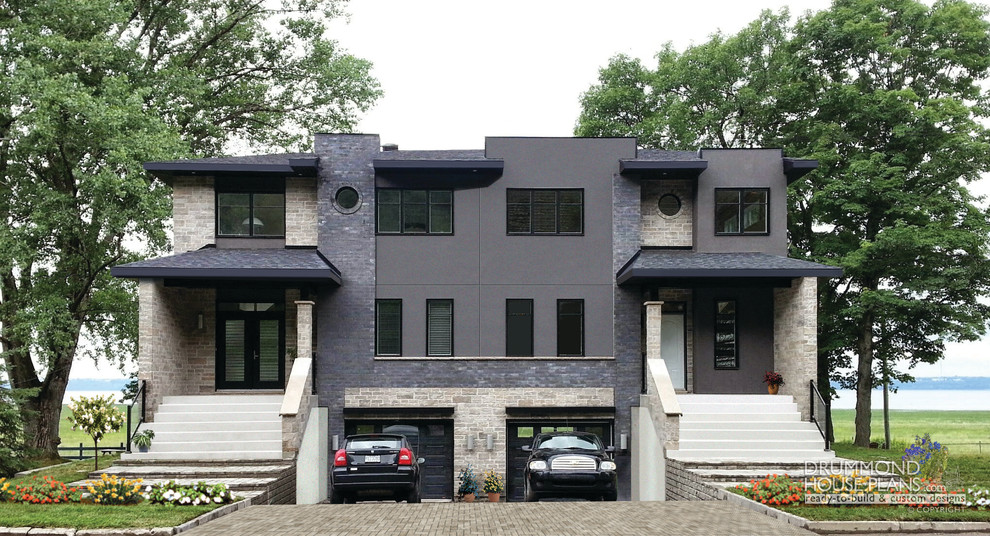 Modelo de fachada de casa bifamiliar negra actual grande de dos plantas con revestimiento de piedra
