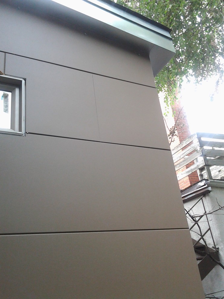 Kleines, Einstöckiges Modernes Haus mit Faserzement-Fassade und brauner Fassadenfarbe in Montreal