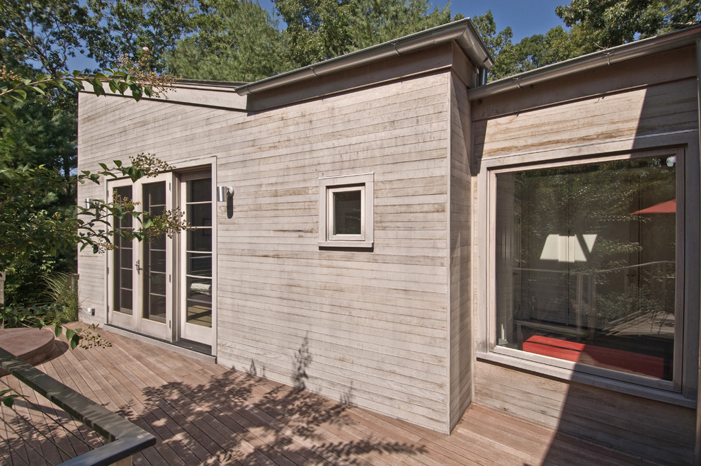 Inspiration for a modern house exterior in New York with wood cladding.