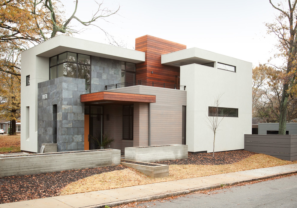 Idée de décoration pour une façade de maison minimaliste de taille moyenne et à un étage avec un revêtement mixte.