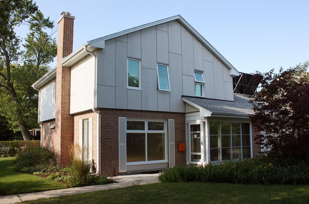 Idee per la facciata di una casa beige moderna a due piani con rivestimento con lastre in cemento