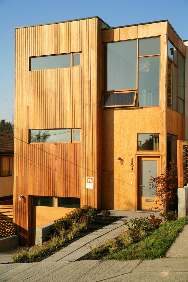 Design ideas for a modern house exterior in Seattle with wood cladding.