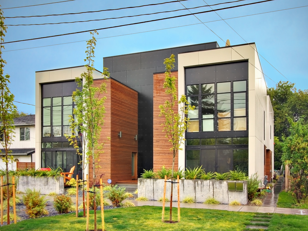 Photo of a modern semi-detached house in Seattle with wood cladding.