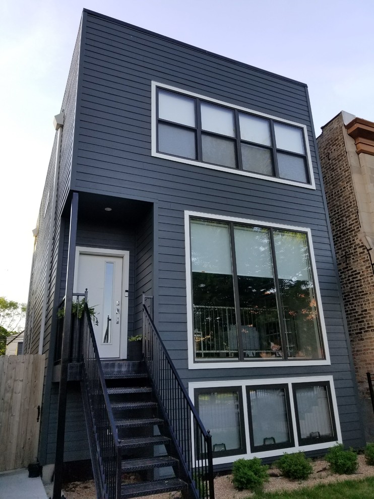 Inspiration for a mid-sized modern gray two-story concrete fiberboard exterior home remodel in Chicago