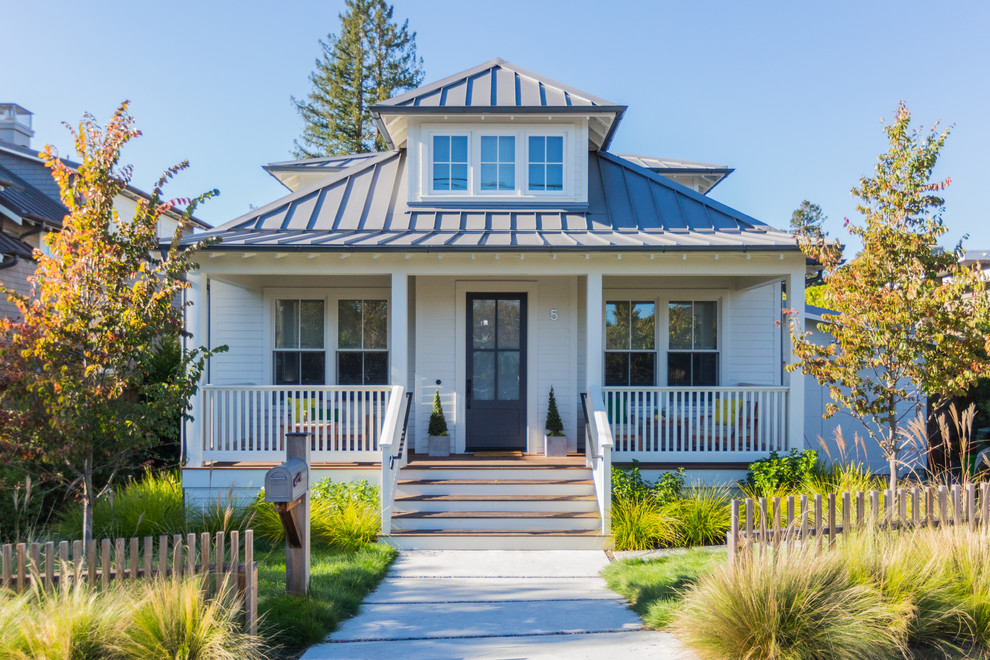 Photo of a white classic bungalow detached house in San Francisco with a hip roof and a metal roof.