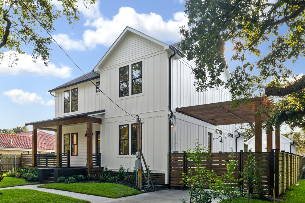 Large country white two-story mixed siding exterior home idea in New Orleans with a mixed material roof