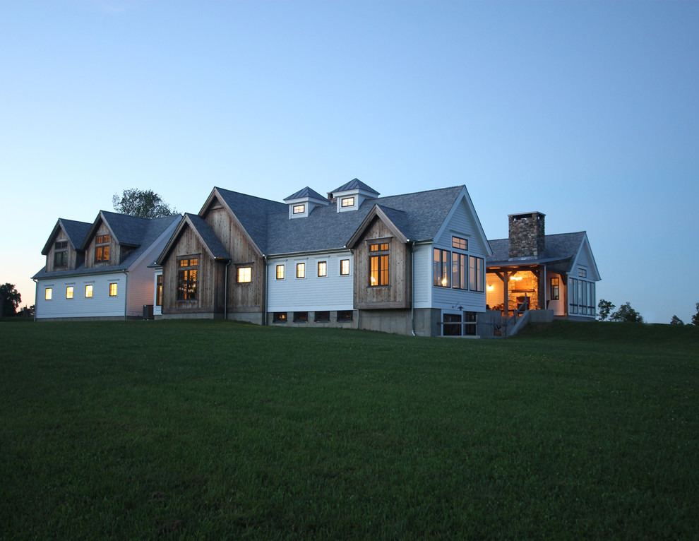 Large country white one-story wood exterior home idea in New York with a mixed material roof